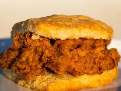 A fried chicken fillet in a split golden biscuit sandwich, photographed on 26 September 2023 at a restaurant in Taipei, Taiwan, a file photograph of a North Carolina style chicken biscuit and not of the Popeyes sandwich