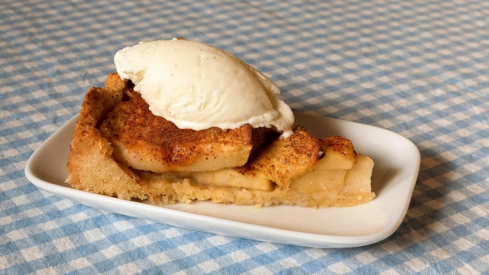 A slice of apple cake with vanilla ice cream, illustrative of the finished bake and not this recipe's own result, photographed in March 2020