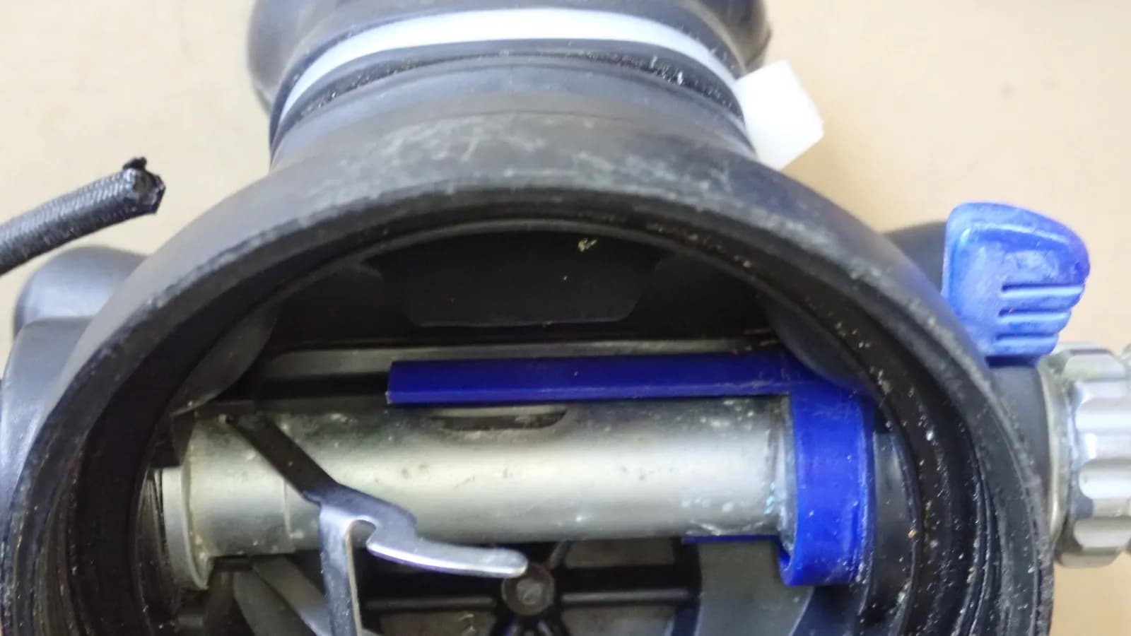 The internals of a scuba demand valve, showing the valve lever and flow deflector