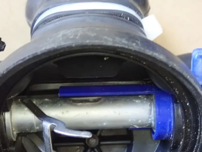 The internals of a scuba demand valve, showing the valve lever and flow deflector