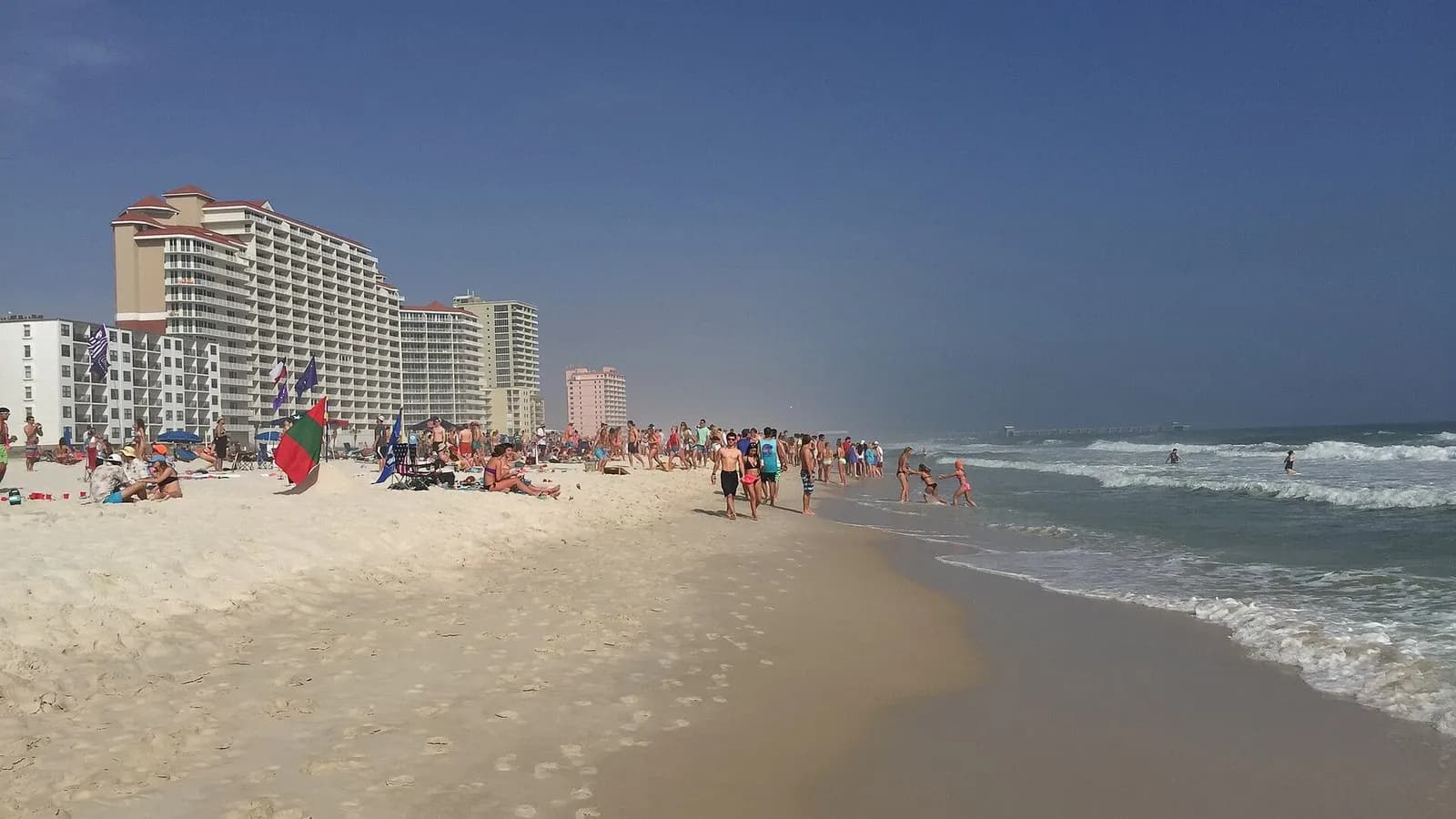 Hotel towers and people on the beach at Gulf Shores, Alabama, photographed in March 2015, a file photograph of a resort town covered by evacuation orders and not of Hurricane Isaias