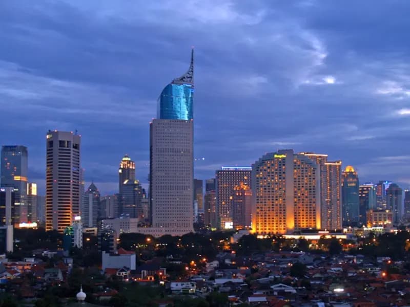 The skyline of Jakarta's central business district at dusk, with office towers lit against a blue evening sky, photographed on 2 March 2008, a file photograph illustrative of Indonesia's capital and not of Friday's trading