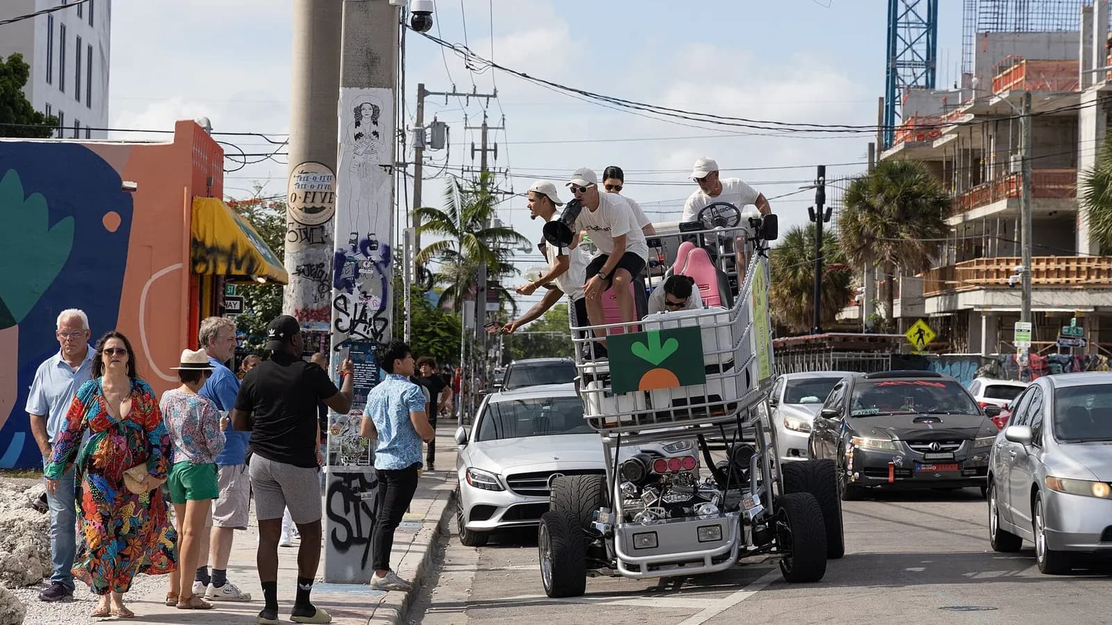 An Instacart-branded motorised shopping cart with a carrot logo, carrying riders, in a street in Miami, Florida, photographed on 2 July 2022, a file photograph illustrative of the company and not of the reported sale talks