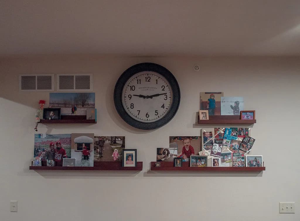 A kitchen clock beside an empty plate on a table in soft morning light, suggesting a fasting window