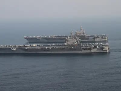 Two United States aircraft carriers in the Persian Gulf during a 2014 carrier relief, a file photograph illustrative of US naval power in the region and not of the current blockade