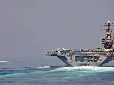 A United States aircraft carrier and an escort transiting the Strait of Hormuz, in an official US Navy photograph