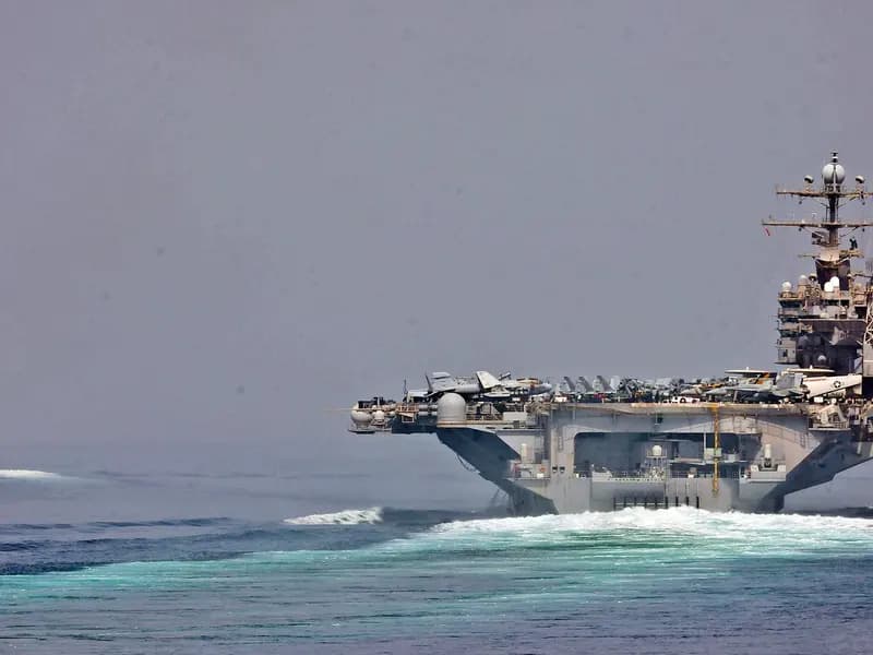 A United States aircraft carrier and an escort transiting the Strait of Hormuz, in an official US Navy photograph