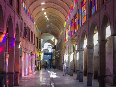 A covered arcade of the Grand Bazaar in Tehran, illustrative of the economy affected by the rial's fall and photographed in August 2015