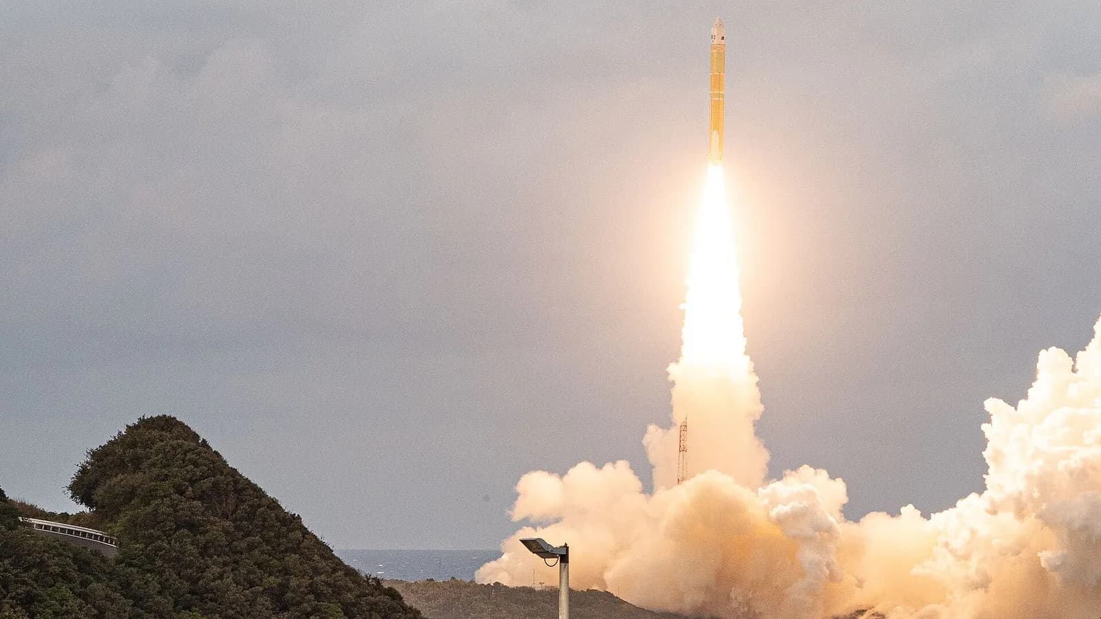 An H3 rocket rising on a column of flame and smoke from the Tanegashima Space Center in Japan, photographed on 2 February 2025 during the launch of a different payload, a file photograph illustrative of the H3 and the launch site and not of the MMX launch