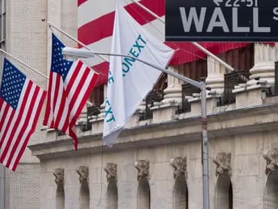 The New York Stock Exchange on Wall Street with flags across its facade, photographed in July 2012