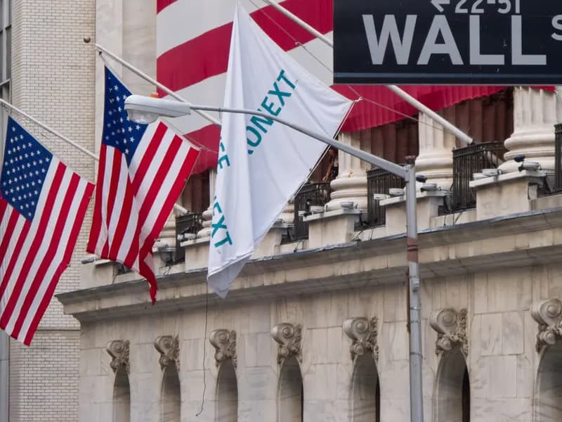 The New York Stock Exchange on Wall Street with flags across its facade, photographed in July 2012