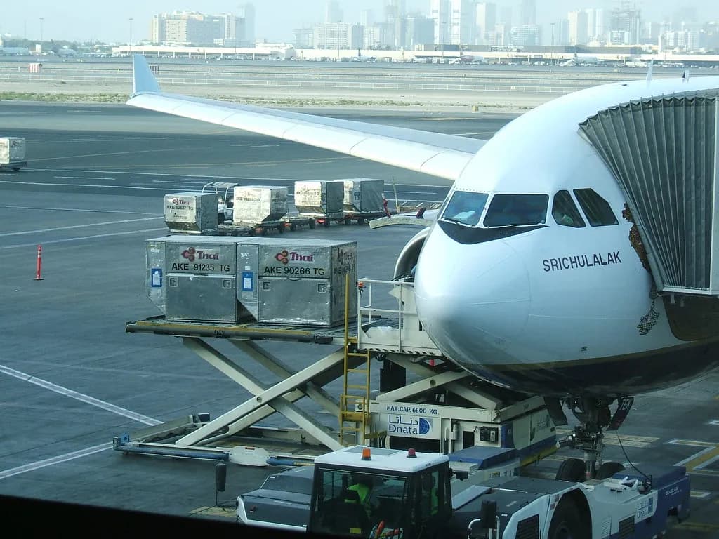 Passengers checking a departure board during disruption at a major airport