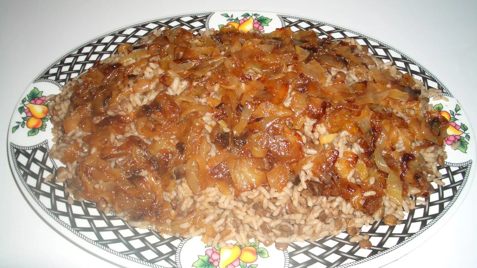 A plate of mujaddara, lentils and rice topped with fried onions