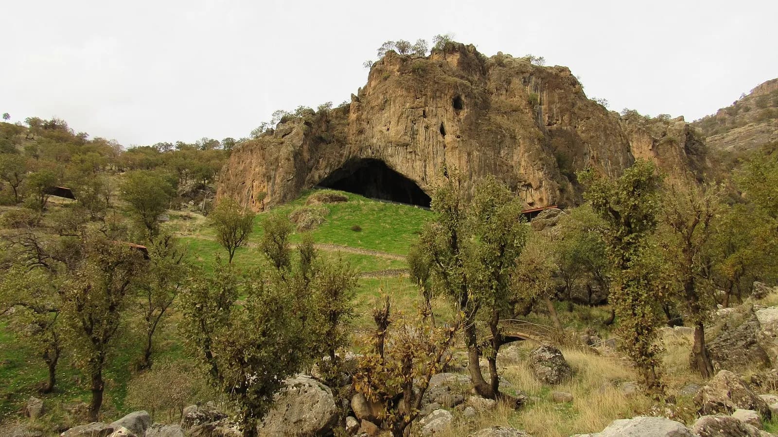The rock outcrop and cave mouth of Shanidar Cave on Bradost Mountain in Iraqi Kurdistan, seen from the hillside, photographed on 28 November 2020, a file photograph of the site and not of the excavation or the bone