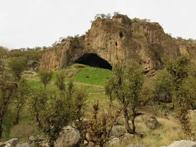 The rock outcrop and cave mouth of Shanidar Cave on Bradost Mountain in Iraqi Kurdistan, seen from the hillside, photographed on 28 November 2020, a file photograph of the site and not of the excavation or the bone