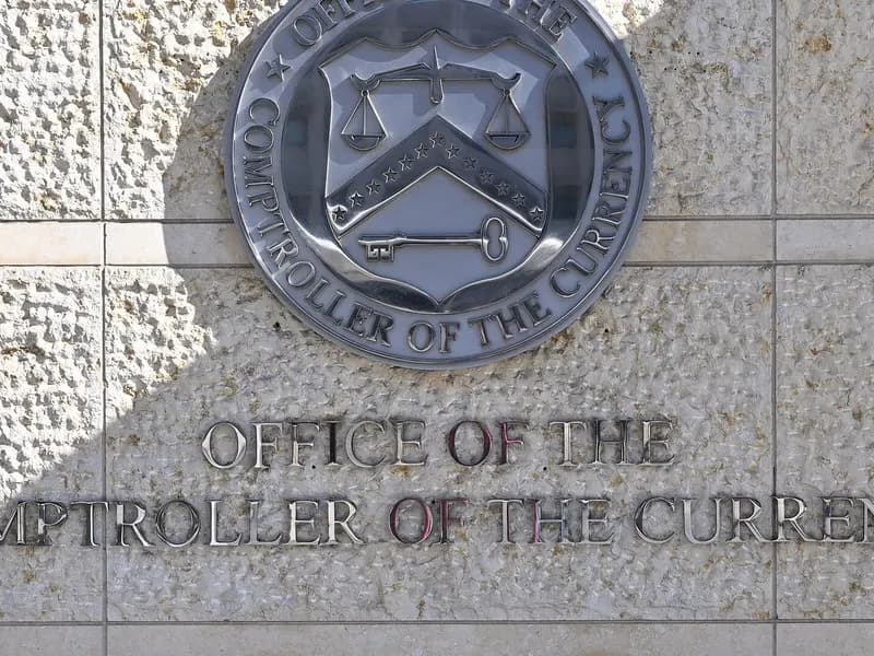 The seal and lettering of the Office of the Comptroller of the Currency on a stone wall outside its headquarters at 400 7th Street SW in Washington, photographed on 10 February 2025, a file photograph of the agency's sign and not of the rule's release