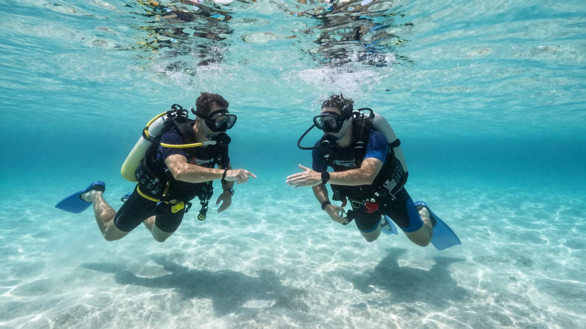 Two divers practising skills in shallow clear water