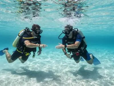 Two divers practising skills in shallow clear water