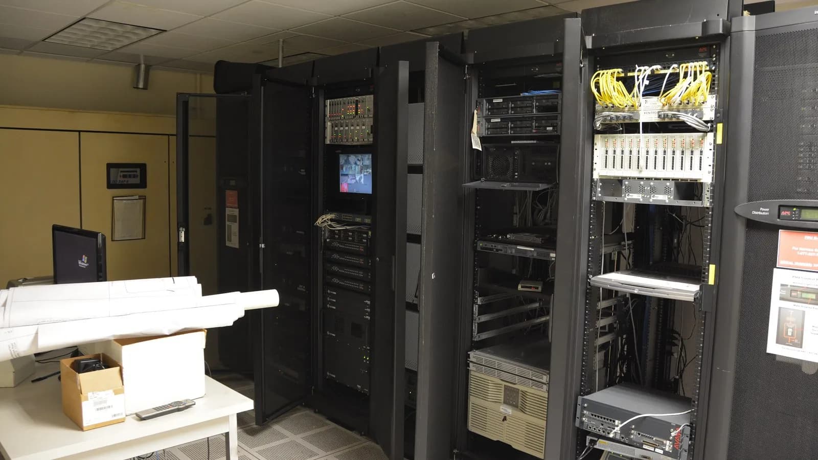 Racks of servers and networking equipment in a machine room, the kind of hardware a frontier model is trained and served on