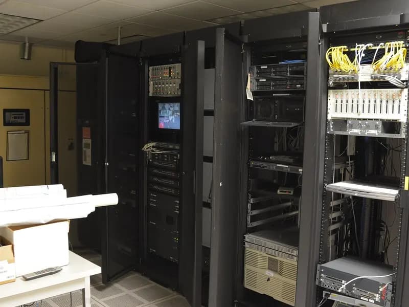 Racks of servers and networking equipment in a machine room, the kind of hardware a frontier model is trained and served on