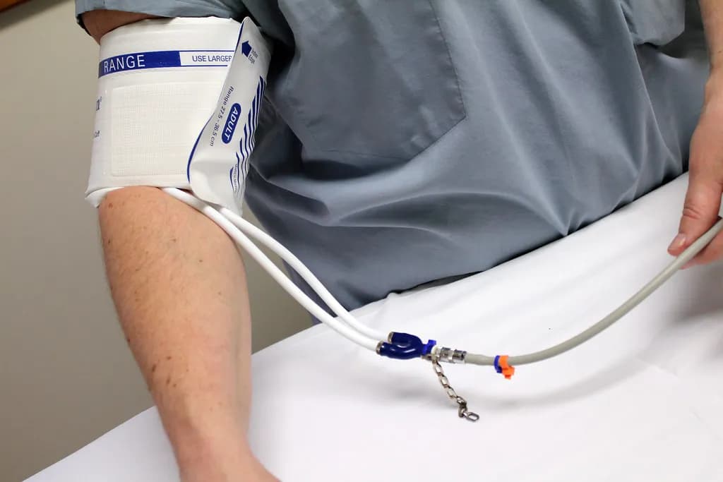 A weekly injection pen device positioned next to a stethoscope on a clinical countertop