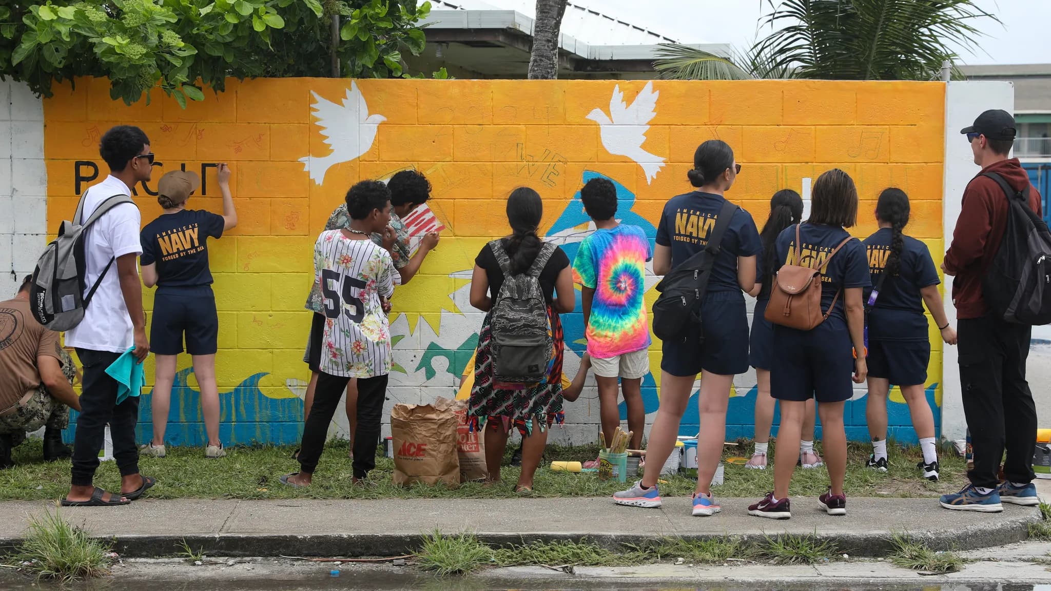 Students learning outdoors in a Pacific island coastal community