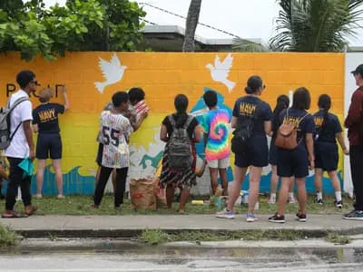 Students learning outdoors in a Pacific island coastal community