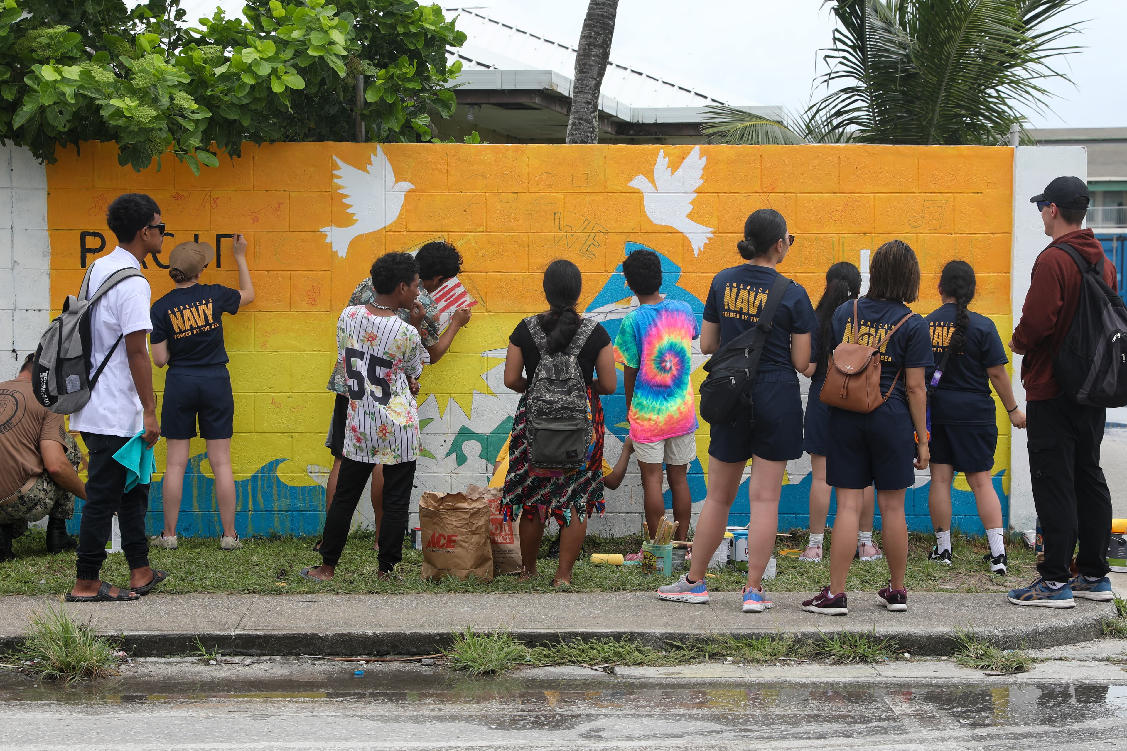 Students learning outdoors in a Pacific island coastal community