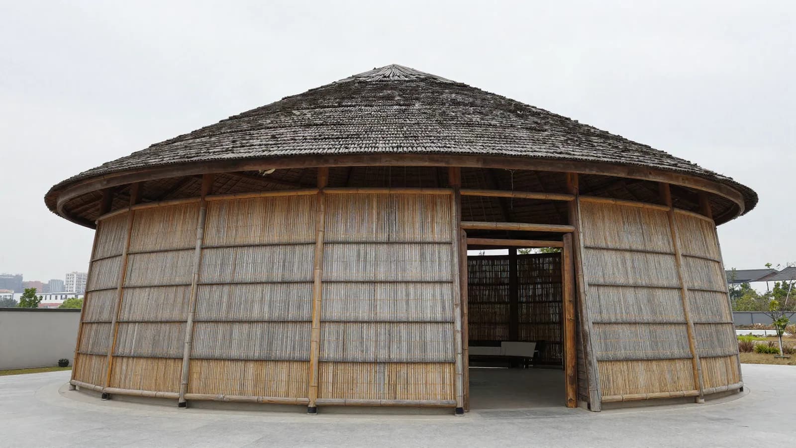 A bamboo pavilion structure seen against the sky