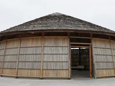 A bamboo pavilion structure seen against the sky