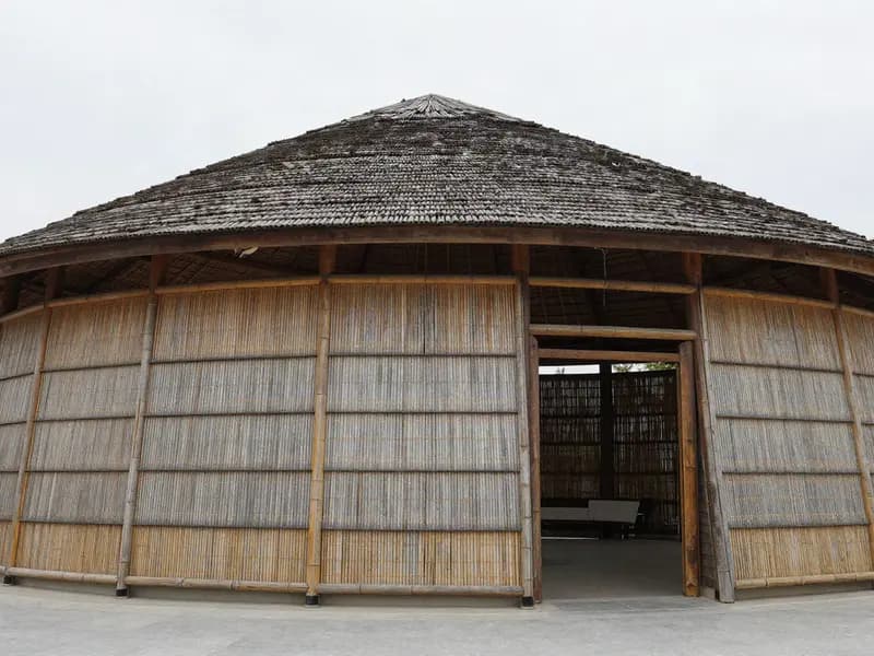 A bamboo pavilion structure seen against the sky
