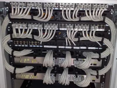 A 19-inch rack of Ethernet switches and patch panels with grey patch cables looped neatly down the sides, photographed on 23 October 2009, a file photograph illustrative of hosting infrastructure and not of any provider named