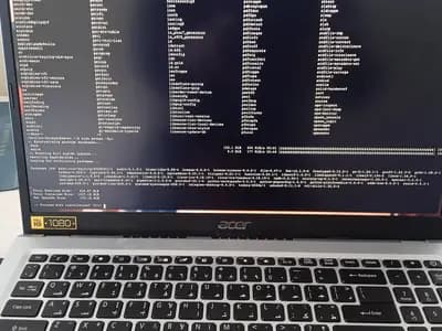 An Acer laptop showing a Linux terminal in the middle of a package update, photographed around 7 March 2026, a file photograph illustrative of updating server software and not of a PHP update
