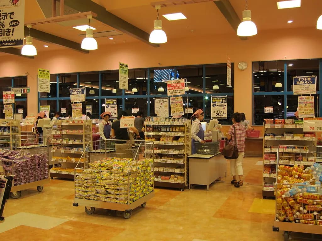 Brightly lit grocery store aisle with multiple brands of high-protein cereal, bars, and snack products