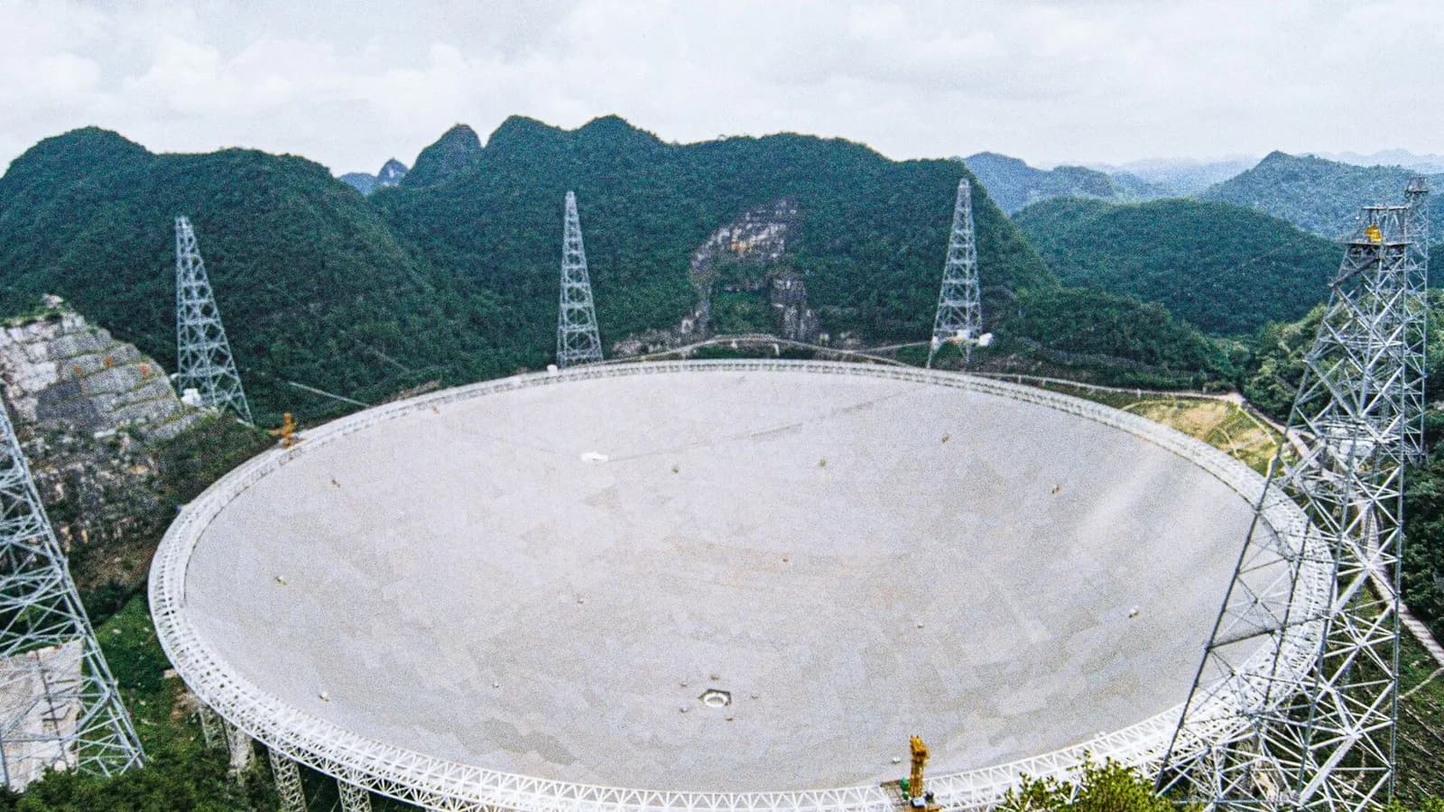 The 500-metre FAST radio telescope dish in its forested karst valley in Guizhou, China, photographed on 10 August 2025, a file photograph of the telescope that observed the pulsar and not from this week