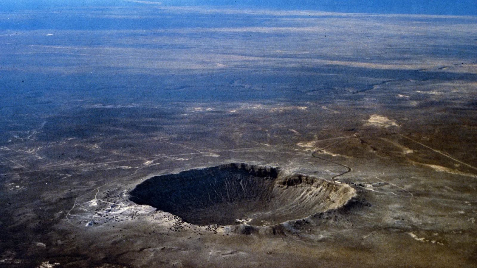 Barringer Crater in Arizona, an aerial view of a well known impact crater illustrative of the type of structure confirmed in Quebec, and not the Uhackatik site itself, photographed by the USGS