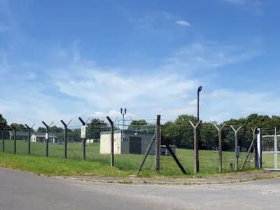 A security fence around RAF Fairford in Gloucestershire, the air base near which the five men were arrested, photographed in June 2022