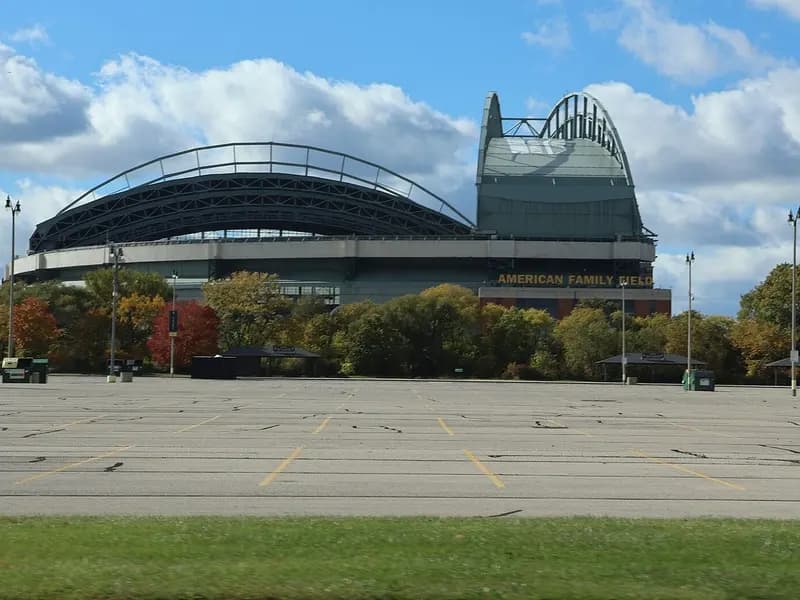 American Family Field in Milwaukee, home of the Brewers, with its retractable roof seen across an empty car park under a cloudy sky, photographed on 20 October 2023, a file photograph of the ballpark and not from this year's playoffs