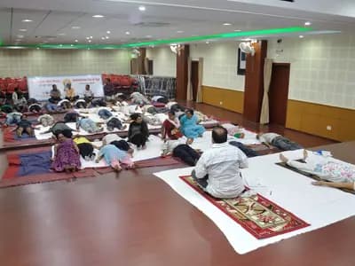 People lying in savasana, the resting pose, at a yoga session in Kolkata in June 2015