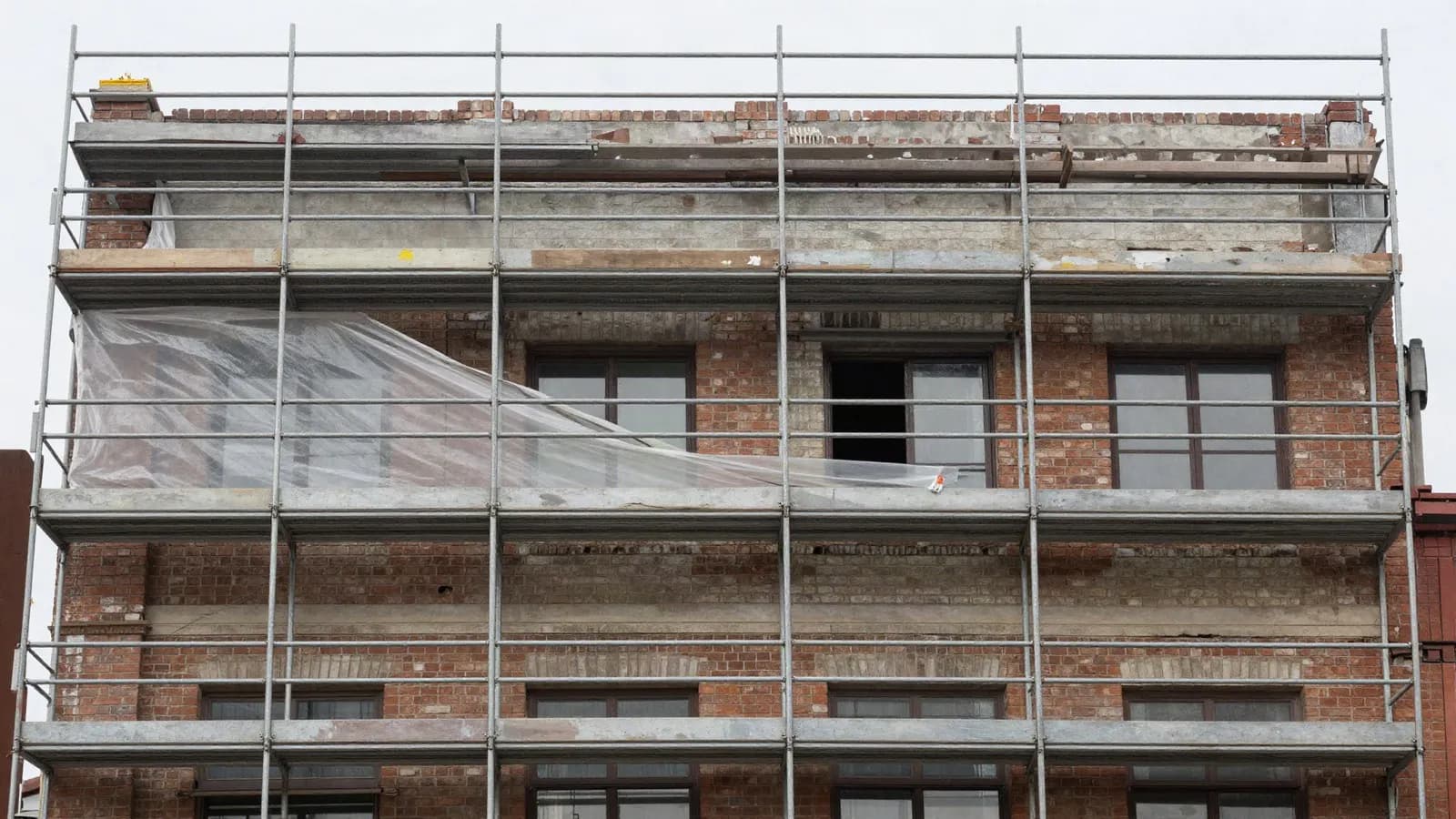 Scaffolding against the retained facade of an older building under refurbishment