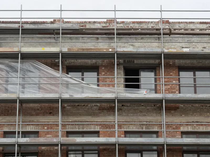 Scaffolding against the retained facade of an older building under refurbishment
