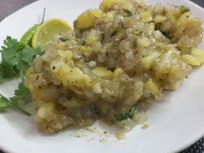 A plate of sabudana khichdi, the tapioca pearls translucent and separate rather than clumped, finished with coriander and lime