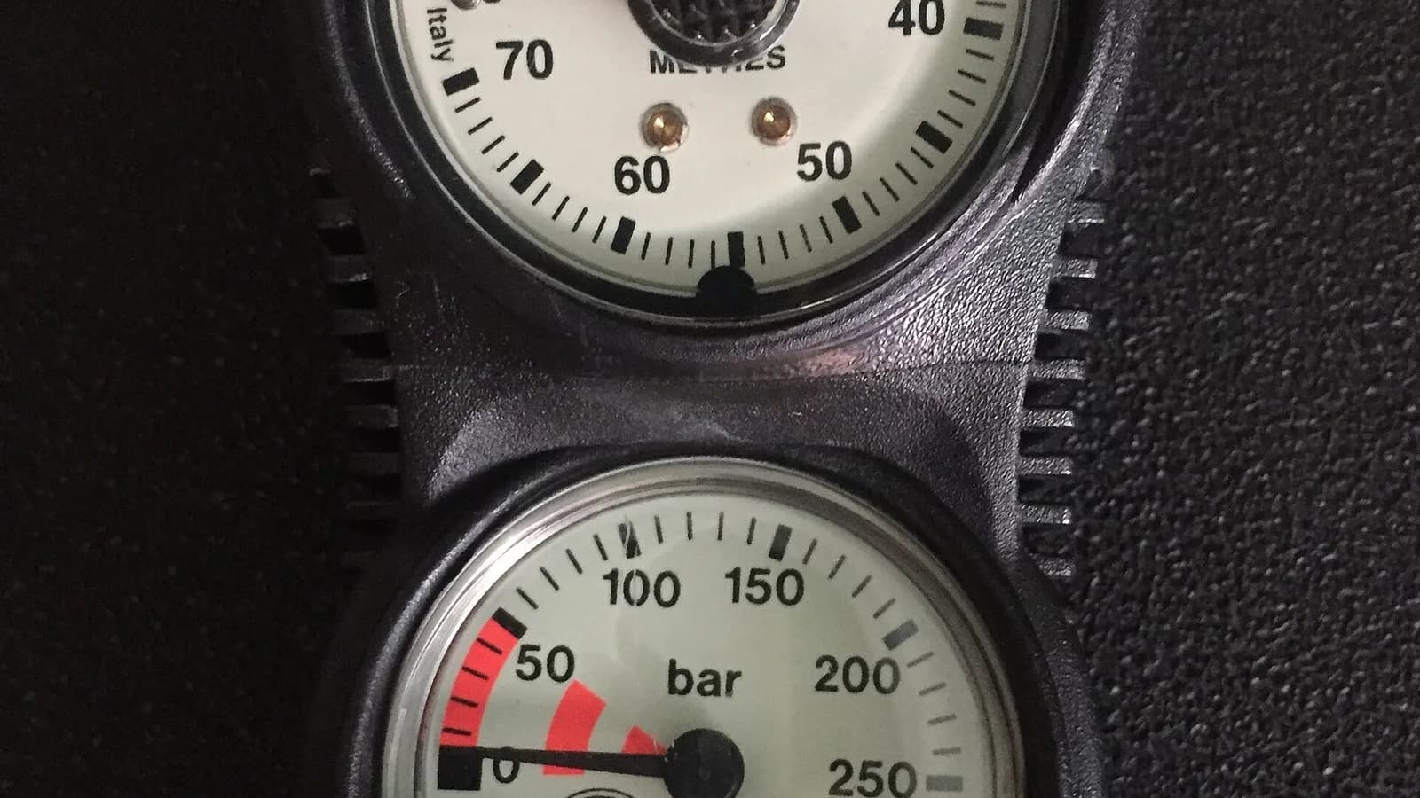 A close-up of a depth gauge reading in metres above a submersible pressure gauge reading in bar on a scuba console, photographed on 10 July 2017, a file photograph of the instruments used to track gas