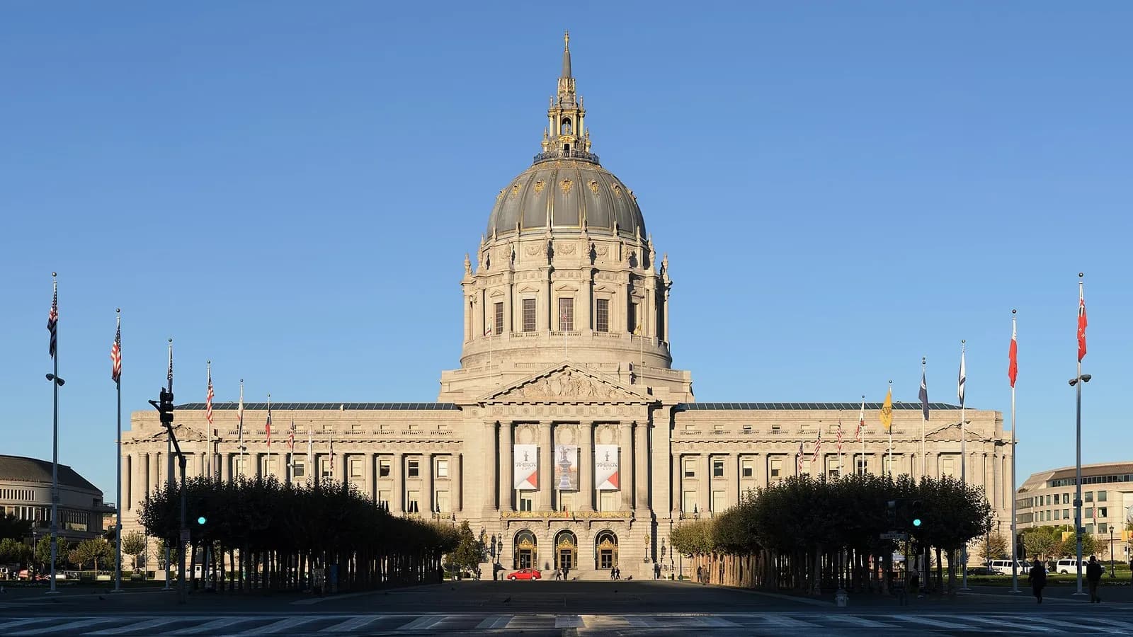The front of San Francisco City Hall, with its dome above the colonnaded facade and flags in front, photographed on 26 September 2013, a file photograph of the seat of city government and not of this week's signing