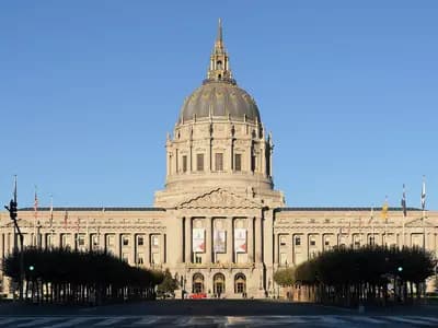The front of San Francisco City Hall, with its dome above the colonnaded facade and flags in front, photographed on 26 September 2013, a file photograph of the seat of city government and not of this week's signing