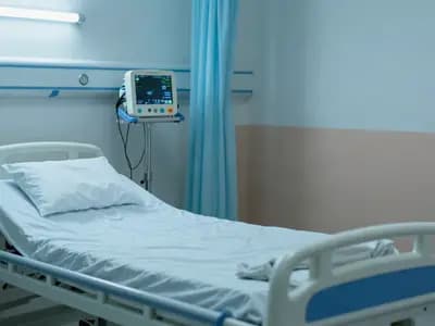 An empty intensive care bay with monitoring equipment