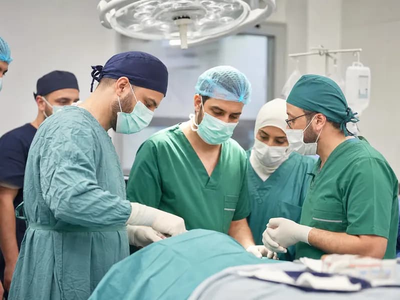 Volunteer surgeons and local medical staff preparing for an urgent hospital procedure