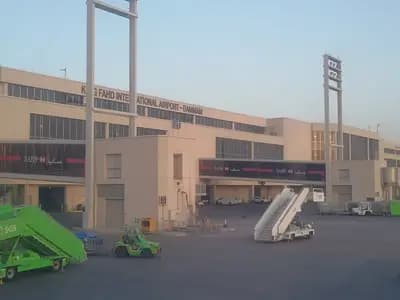 The passenger terminal of King Fahd International Airport in Dammam seen from the apron, with floodlight masts and ground-handling steps in the foreground, photographed on 13 March 2018, a file photograph of the airport and not of Wednesday's attack