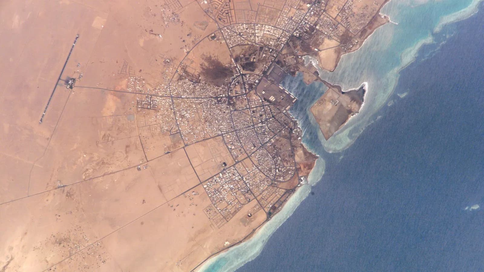 The port and city of Yanbu on Saudi Arabia's Red Sea coast, where the East-West pipeline ends, seen from the International Space Station in 2002