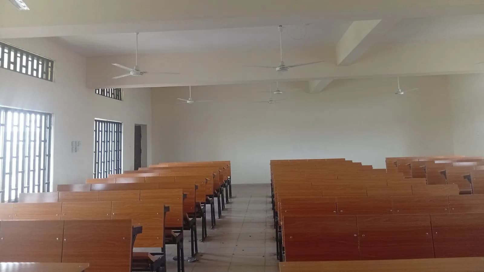 Rows of empty desks in a classroom